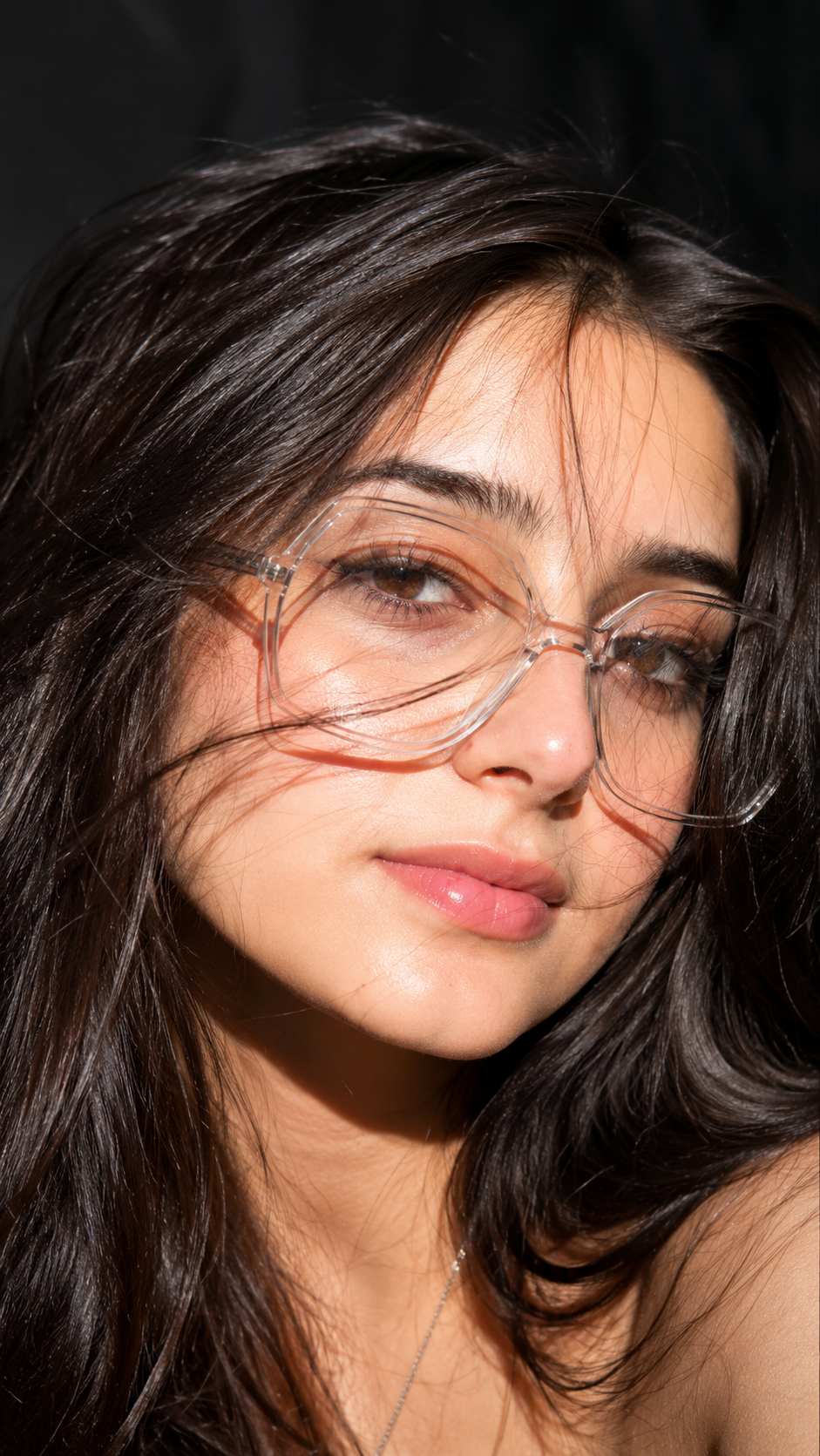 Harsh Sunlight Glasses Portrait AI photo editing prompt result showing an extreme close-up in harsh midday sunlight with transparent glasses and flowing dark hair